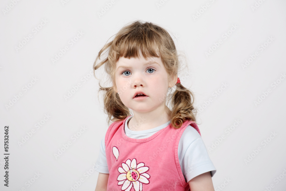 Little beautiful girl in pink looks at camera on white backgroun Little beautiful girl in pink looks at camera on white backgroun