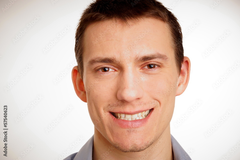 Fototapeta premium Portrait of a smiling young man at shirt close up