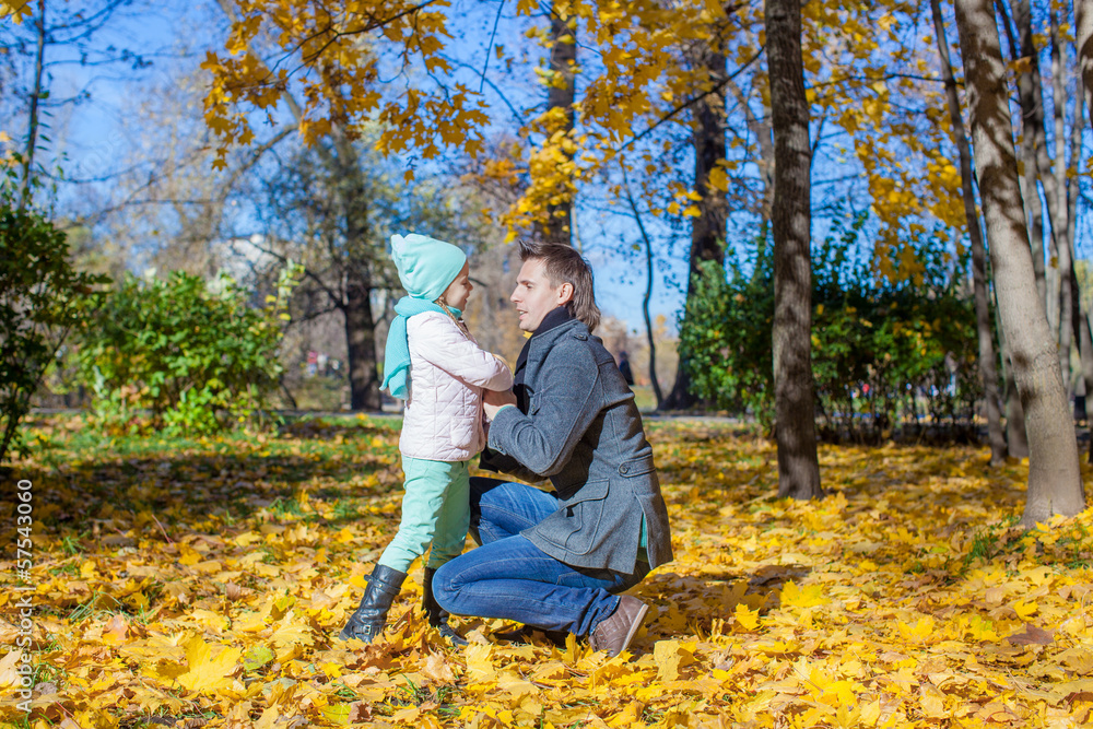 Happy father and little girl in autumn park
