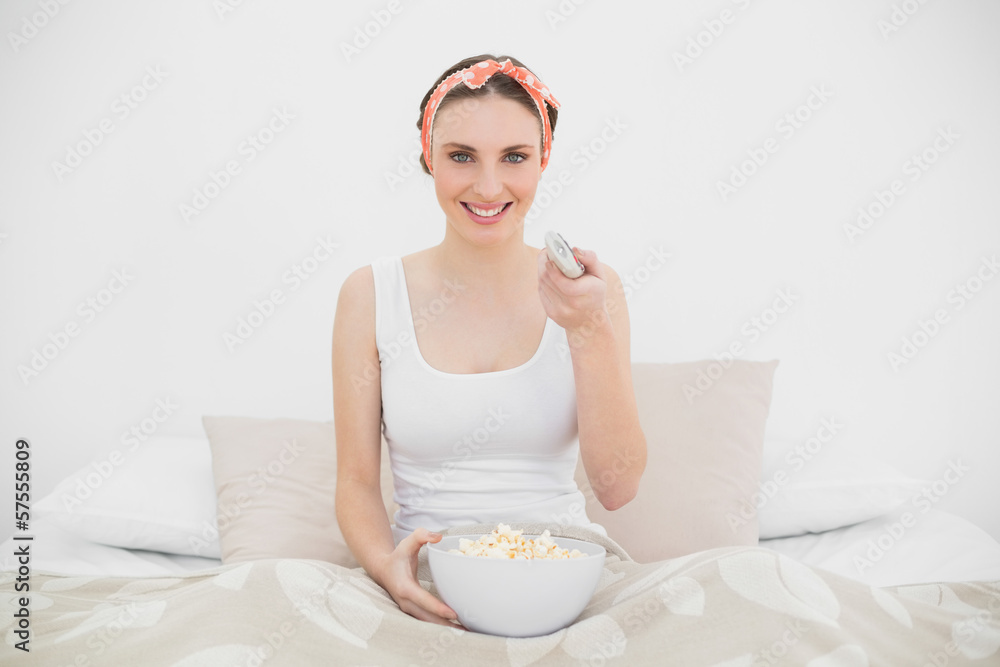 Smiling woman watching television Smiling woman watching television