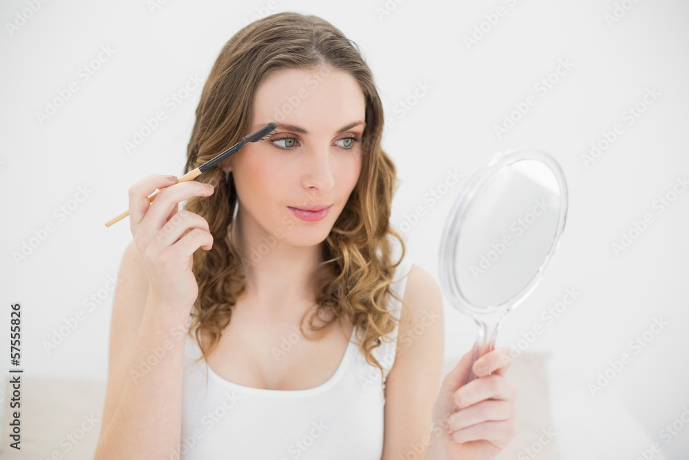 Pretty woman using an eyebrow pen Pretty woman using an eyebrow pen
