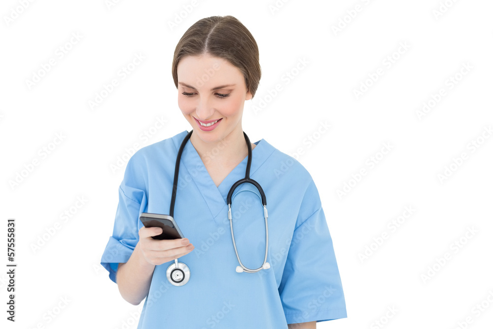Young woman doctor looking at her smartphone Young woman doctor looking at her smartphone