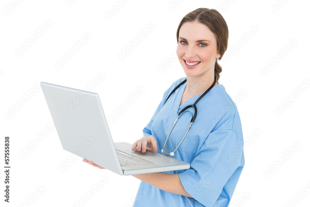 Young female doctor working with her notebook and smiling into t Young female doctor working with her notebook and smiling into t