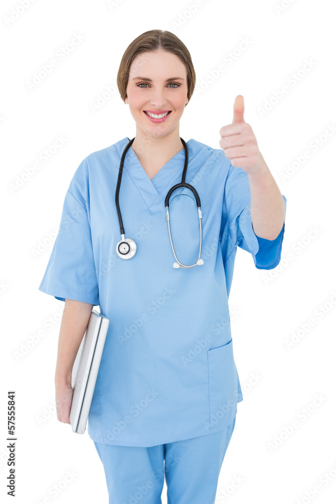 Young female doctor holding a white notebook and putting thumbs Young female doctor holding a white notebook and putting thumbs