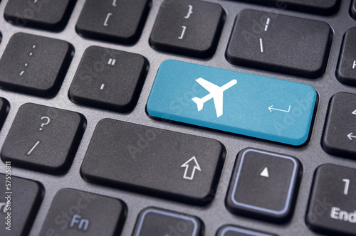 online booking of flight ticket, with plane sign on keyboard