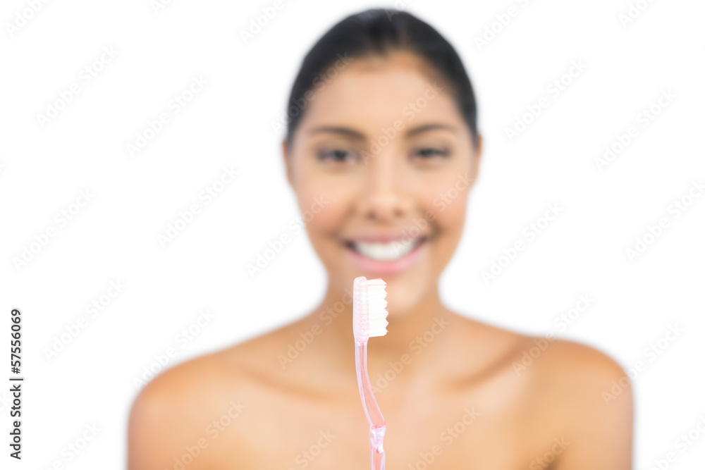Happy nude brunette holding toothbrush Happy nude brunette holding toothbrush