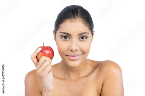 Pleased nude brunette holding red apple