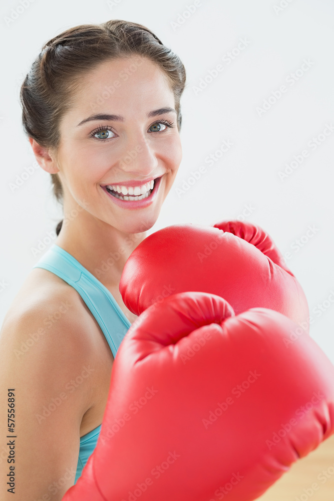 Close-up portrait of a beautiful smiling woman in red boxing glo Close-up portrait of a beautiful smiling woman in red boxing glo