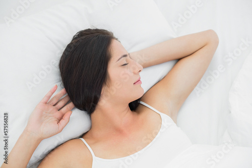 Beautiful woman sleeping in bed with eyes closed