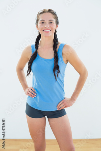 Billede på lærred Smiling woman in sportswear and plaits