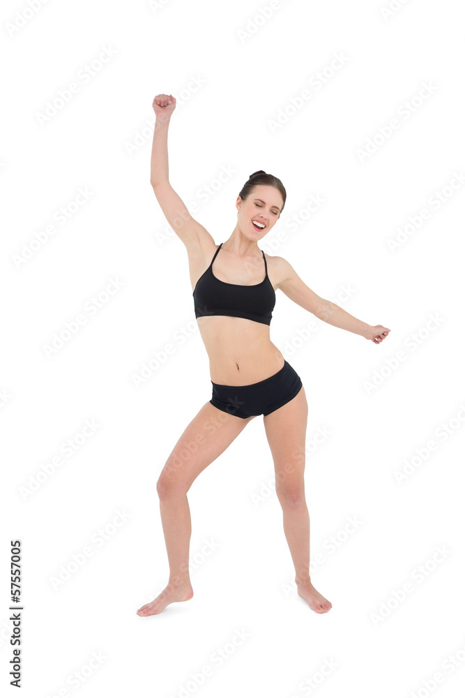 Sporty young woman dancing isolated on white background