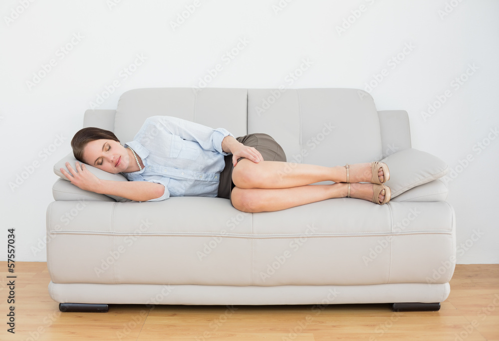 Well dressed young woman sleeping on sofa