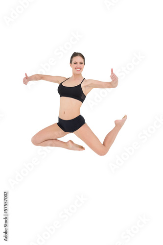 Sporty woman jumping isolated on white background © lightwavemedia