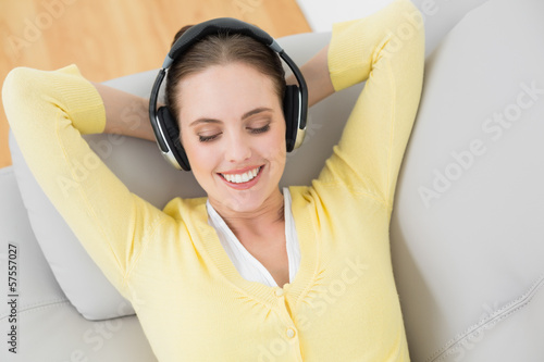 Woman enjoying music through headphones