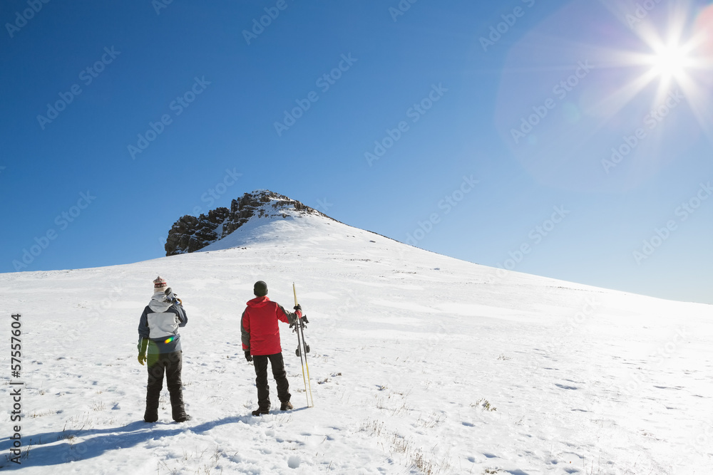 Skiers on snow covered landscape on a sunny day