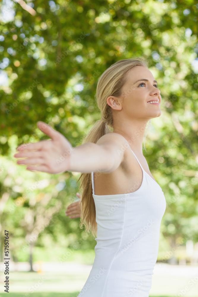 Side view of cheerful attractive woman doing yoga spreading her Side view of cheerful attractive woman doing yoga spreading her