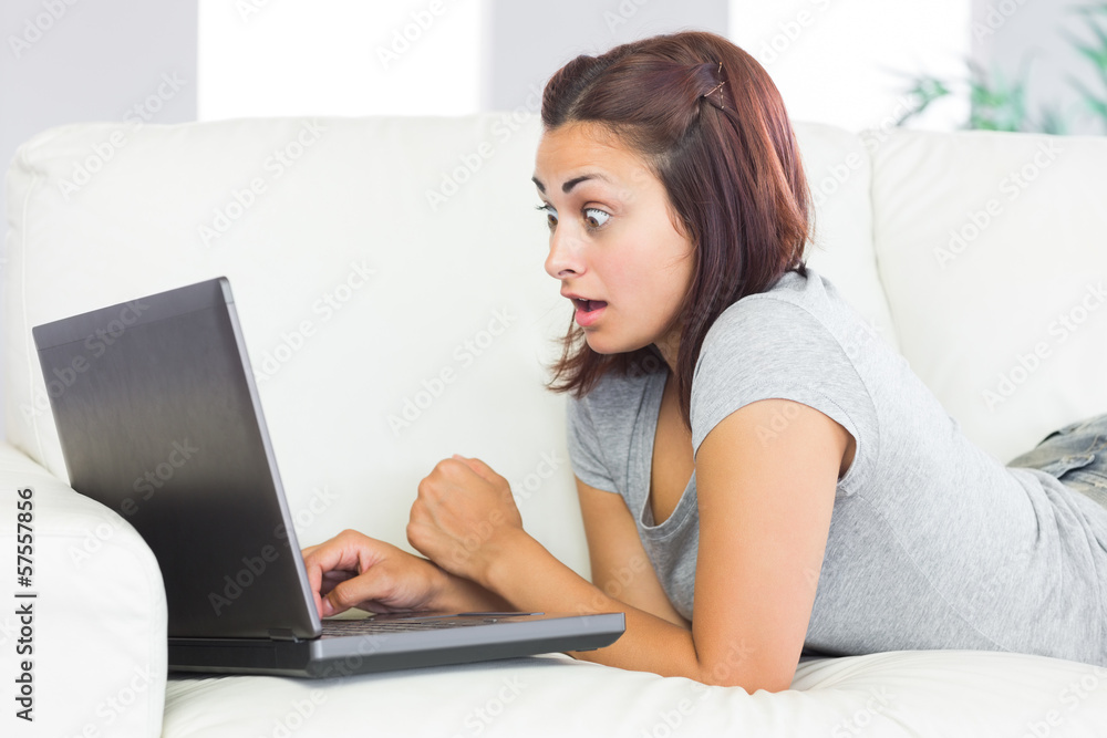 Astonished gorgeous woman working with her notebook Astonished gorgeous woman working with her notebook