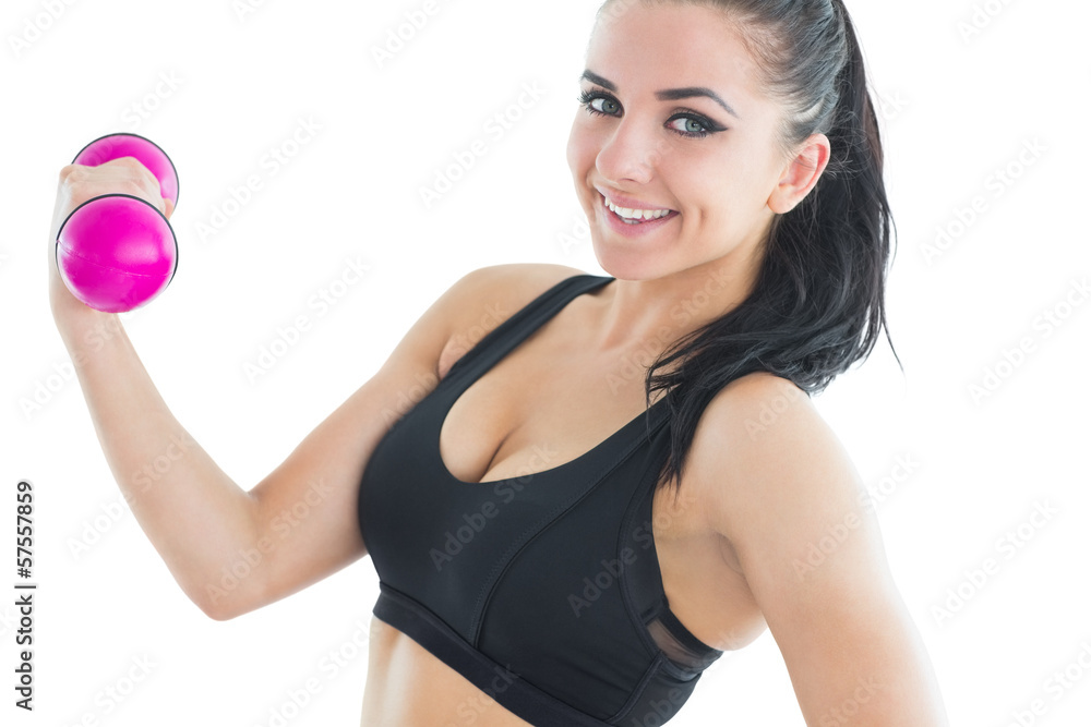Cheerful active woman training with pink dumbbells Cheerful active woman training with pink dumbbells
