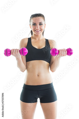 Front view of gorgeous active woman making use of dumbbells