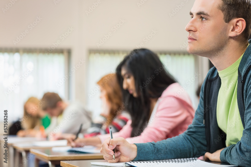 Young students writing notes in classroom Young students writing notes in classroom