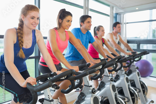 Five people working out at spinning class