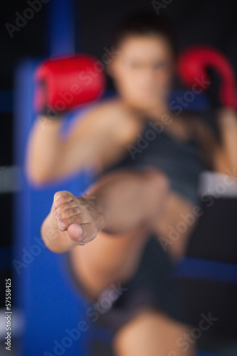 Bemale boxer performing an air kick