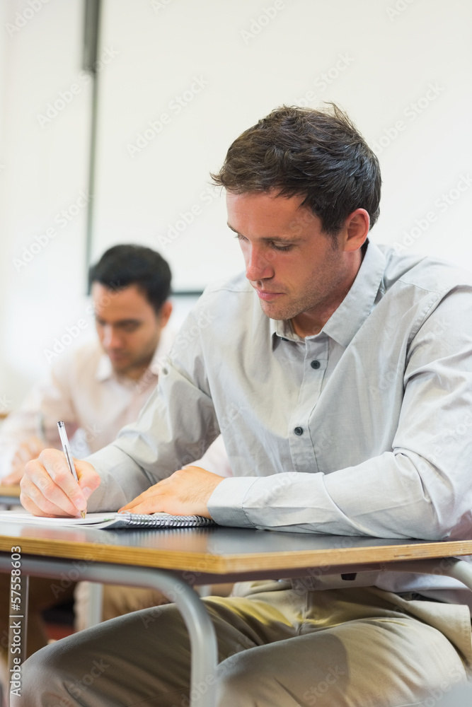 Mature students taking notes in classroom Mature students taking notes in classroom