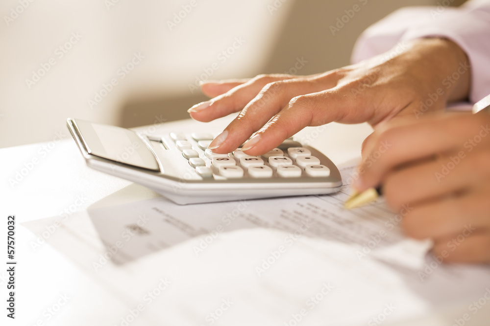 Woman's hands with a calculator and pen, Accounting. Woman's hands with a calculator and pen, Accounting.