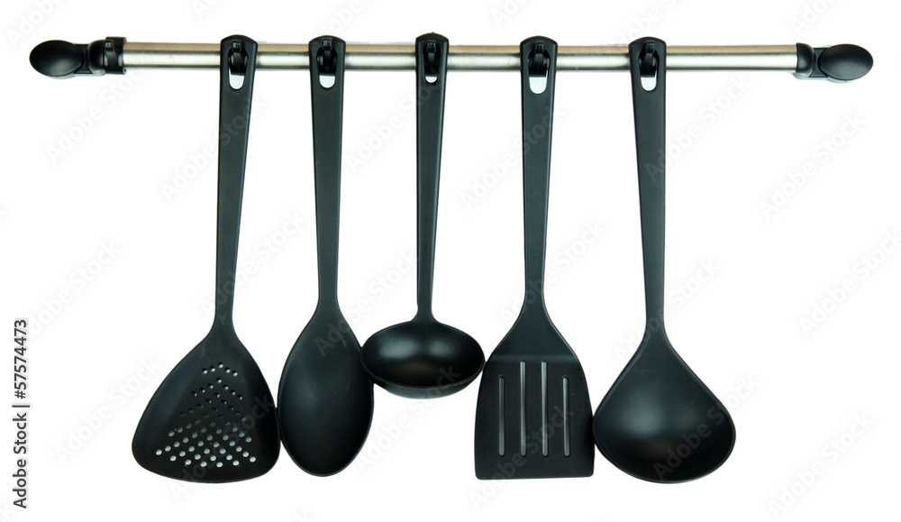 Plastic kitchen utensils on silver hooks isolated on white Plastic kitchen utensils on silver hooks isolated on white