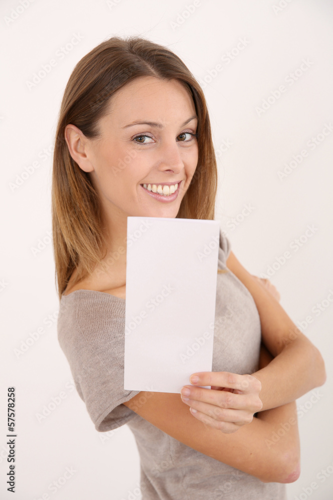 Cheerful girl on white background holding leaflet for message Cheerful girl on white background holding leaflet for message