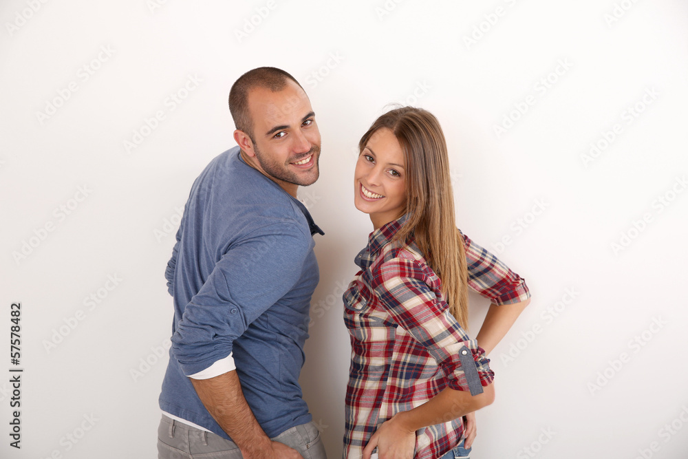 Smiling couple standing on white background Smiling couple standing on white background
