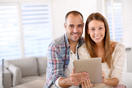 Young couple at home websurfing on internet