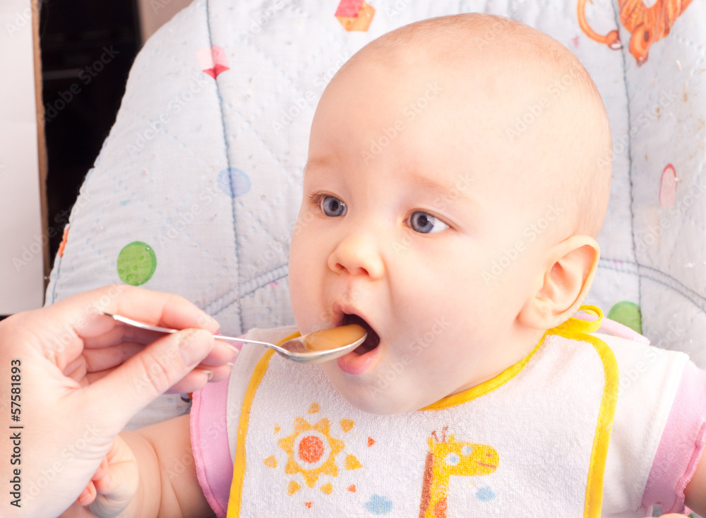 Little baby feeding with a spoon Little baby feeding with a spoon