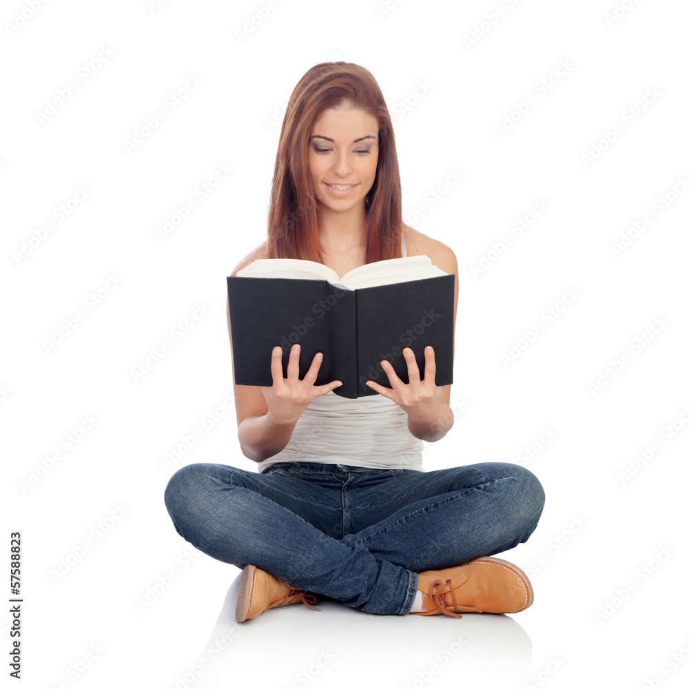 Casual young woman sitting on the floor reading a book Casual young woman sitting on the floor reading a book