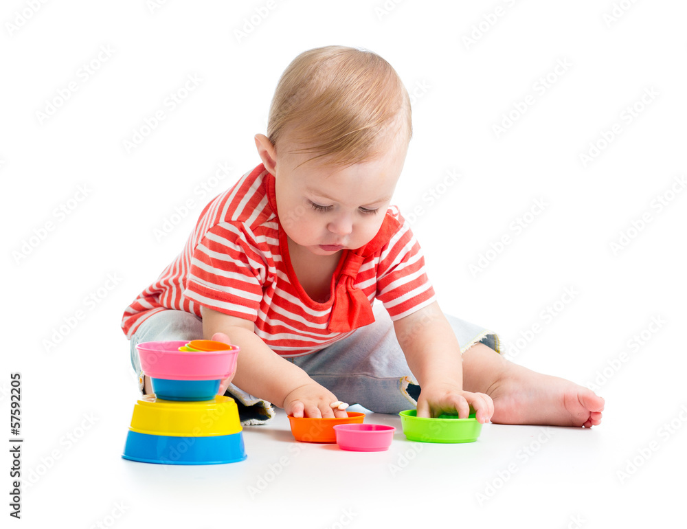 Funny little child is playing with toys while sitting on floor, Funny little child is playing with toys while sitting on floor,