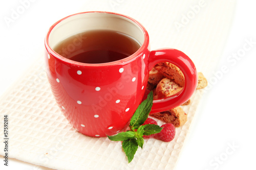 Cup of tea with cookies and raspberries isolated on white