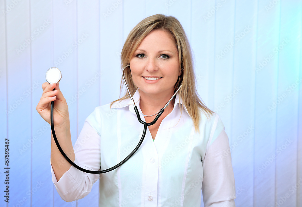 Young beautiful doctor with stethoscope on light background Young beautiful doctor with stethoscope on light background