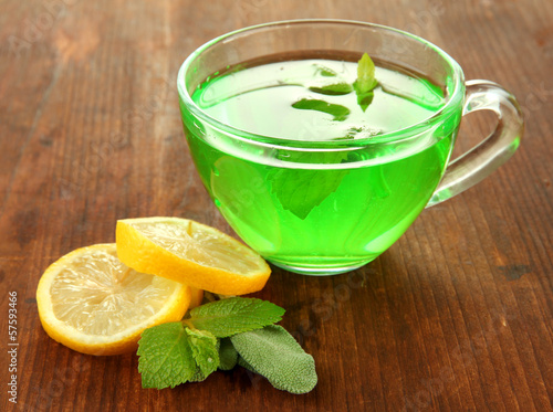 Transparent cup of green tea with lemon and mint