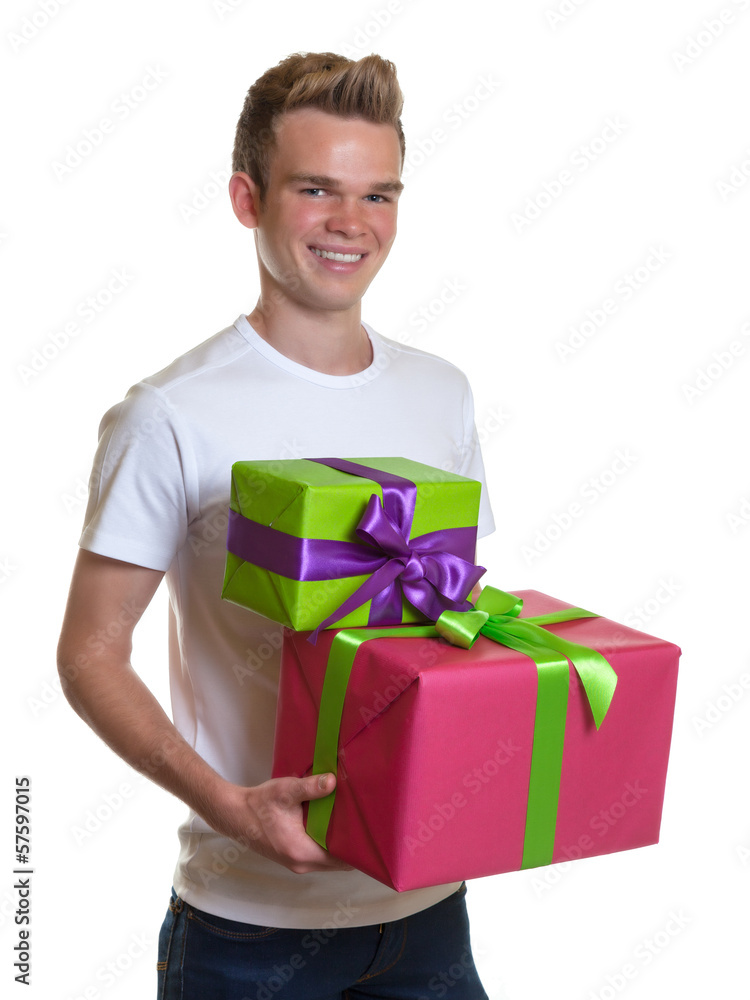 Young man after buying two gifts for christmas Young man after buying two gifts for christmas