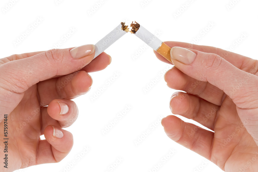 Hands breaking a cigarette in two