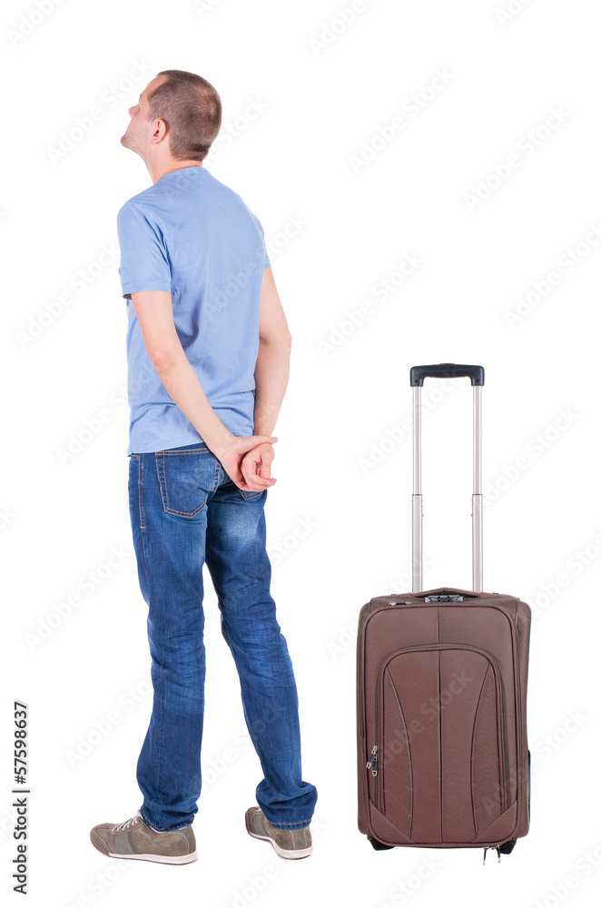 Back view of young man traveling with suitcas. Back view of young man traveling with suitcas.
