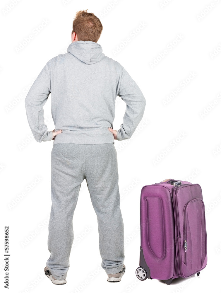 Back view of young man traveling with suitcas. Back view of young man traveling with suitcas.