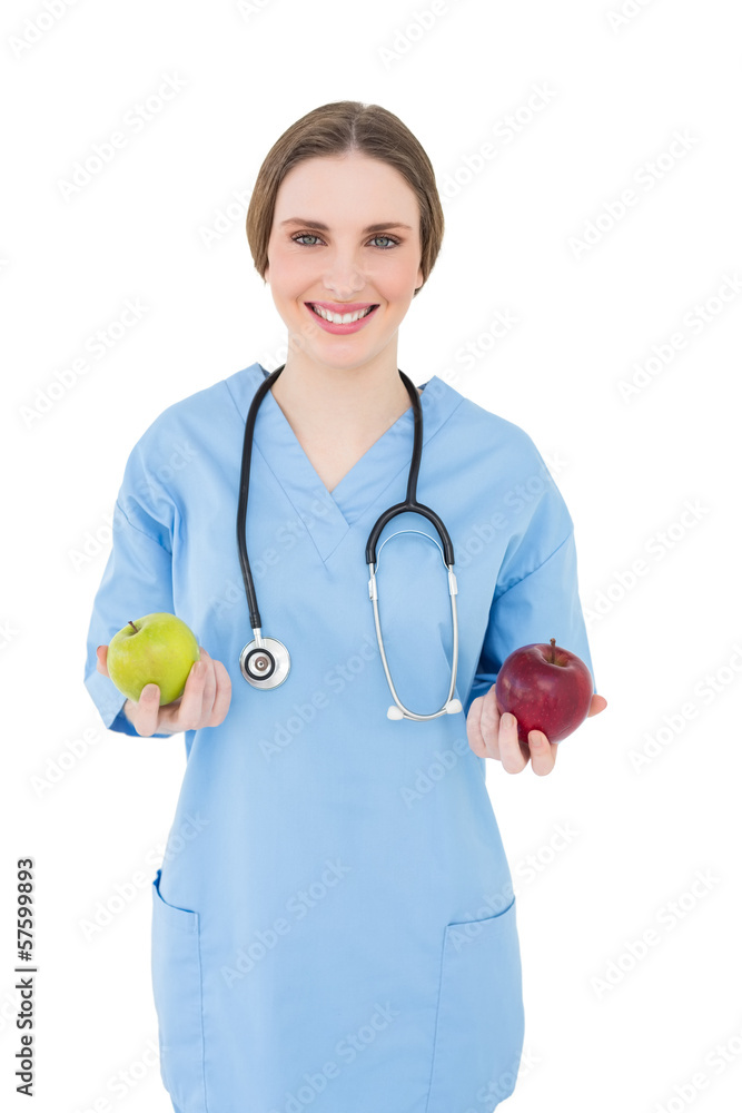 Female doctor holding two apples Female doctor holding two apples