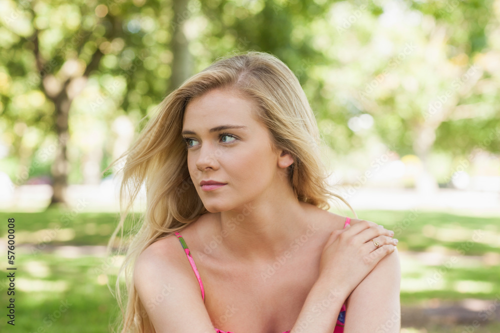 Serious young woman relaxing on a lawn Serious young woman relaxing on a lawn