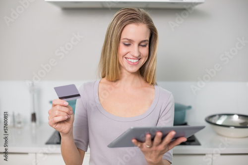 Happy gorgeous model holding tablet and credit card