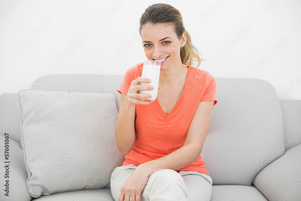 Content peaceful woman holding a glass of milk smiling cheerfull Content peaceful woman holding a glass of milk smiling cheerfull