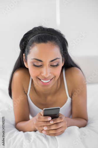 Content dark haired woman text messaging with her smartphone