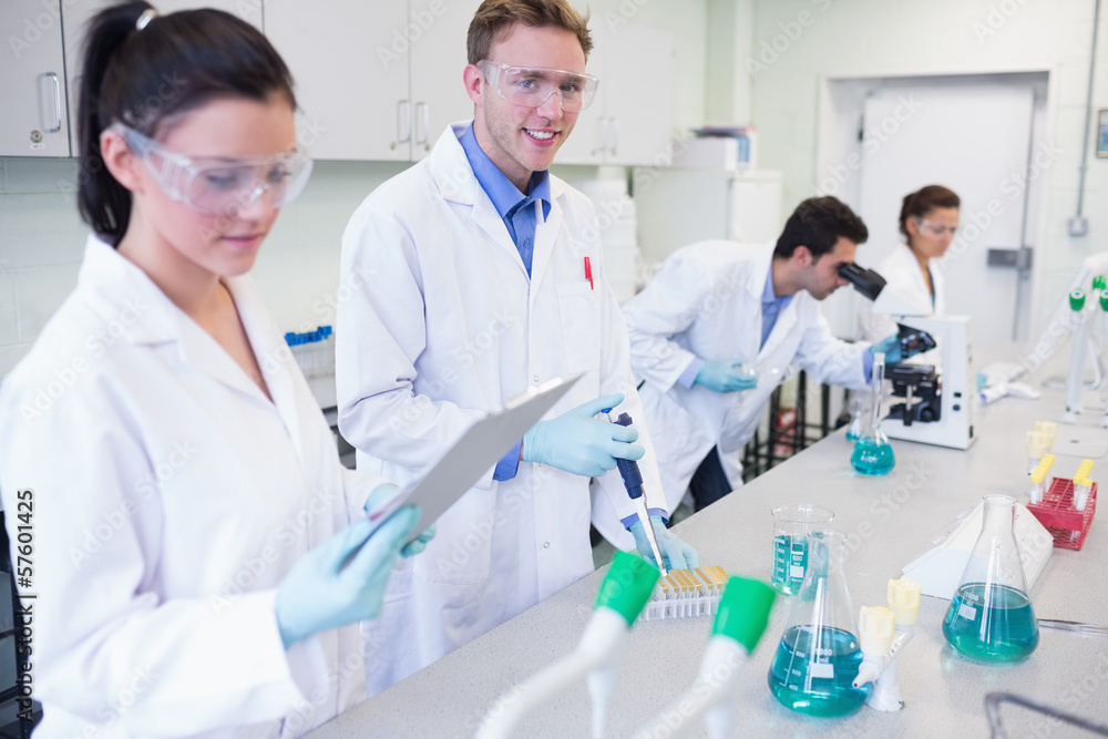 Researchers carrying out experiments in the lab Researchers carrying out experiments in the lab