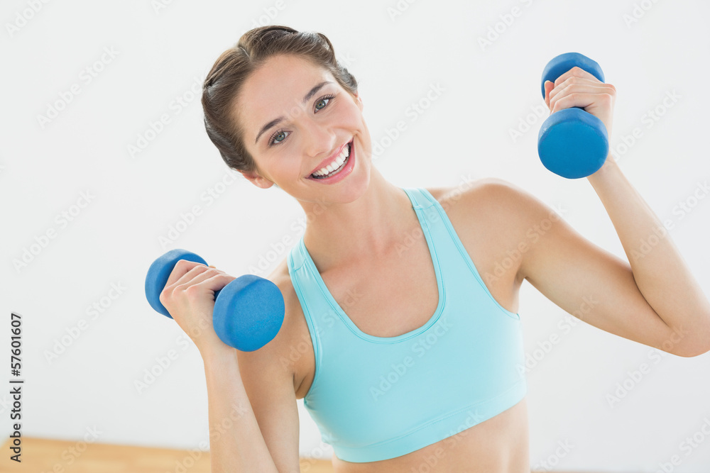 Fit woman with dumbbells at fitness studio Fit woman with dumbbells at fitness studio