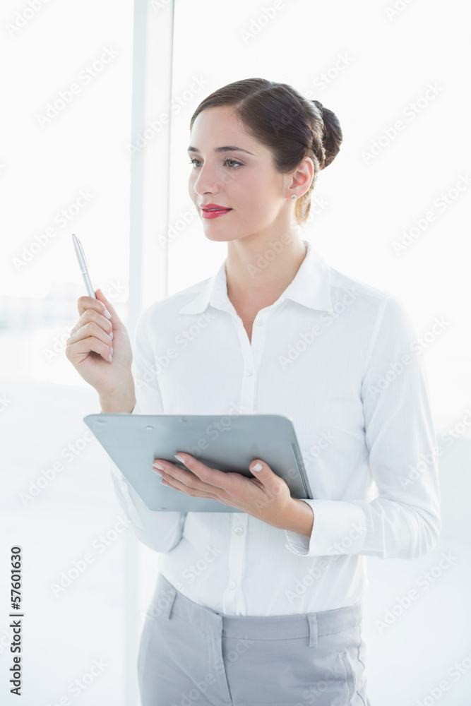 Young business woman with clipboard and pen Young business woman with clipboard and pen